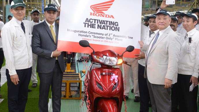 Keita Muramatsu (President & CEO ,HMSI) and HMSI top  officials pose with the first Activa produced in the second assembly line of Honda's fourth plant in India at Vithalapur, Gujarat