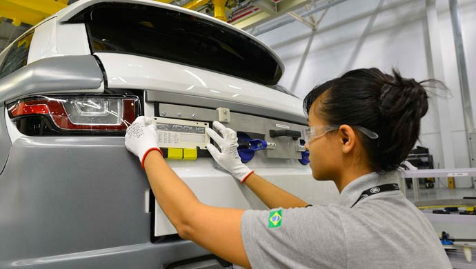 A worker at the JLR Brazil factory