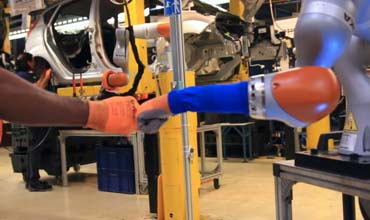 Car workers buddy up with robots in Ford factory