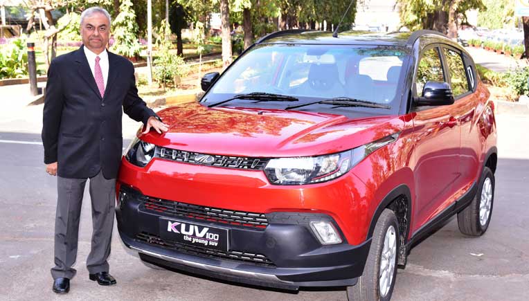 Pravin Shah, President & Chief Executive (Automotive), M&M Ltd with the new KUV100
