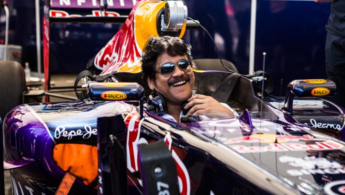Indian film actor Nagarjuna posing inside the F1 car