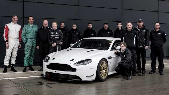 (left to right) Marek Reichman, Andrew Frankel, Dr. Andy Palmer, Alice Powell with the Aston Martin Racing team and the V8 Vantage GT4 race car