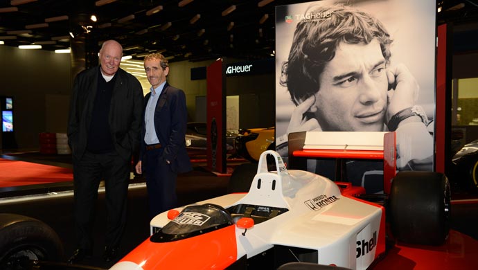 JC Biver & Alain Prost pose next to Senna's F1car.
